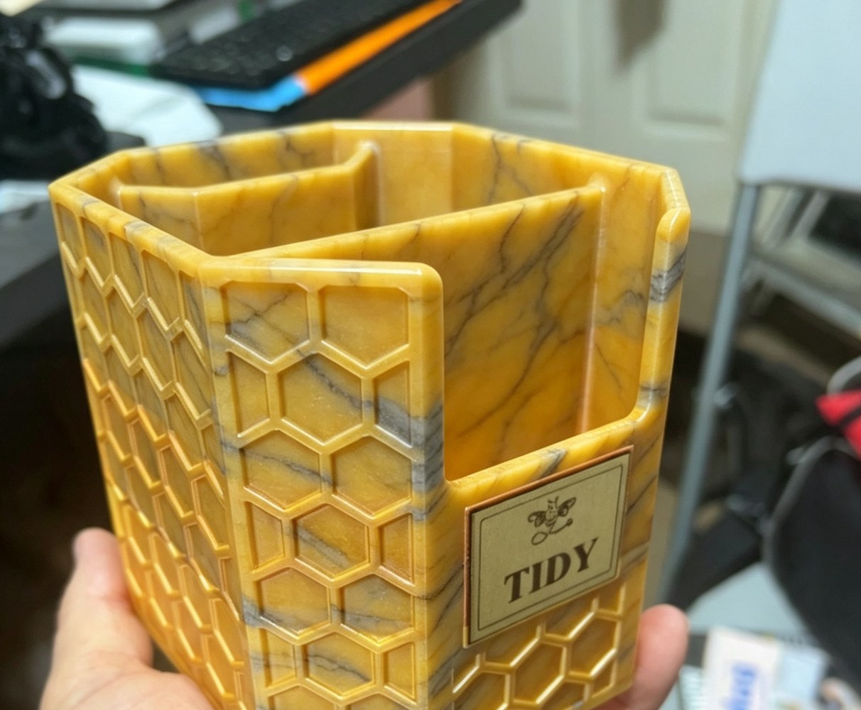 Honey-coloured Bumble Bee Hollow desk tidy with honeycomb texture and black detail lines.